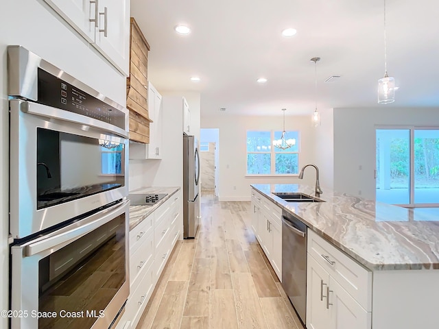 kitchen with white cabinets and hanging light fixtures