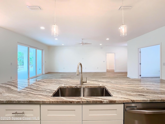 kitchen with ceiling fan, pendant lighting, white cabinets, and sink