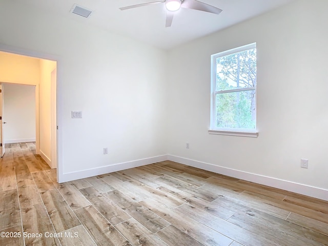 empty room featuring ceiling fan and light hardwood / wood-style floors