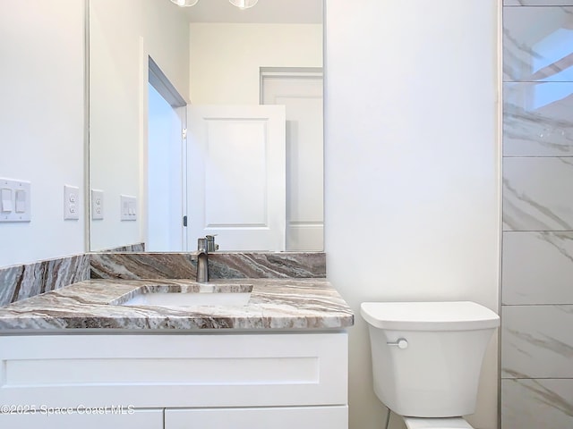 bathroom featuring toilet and vanity