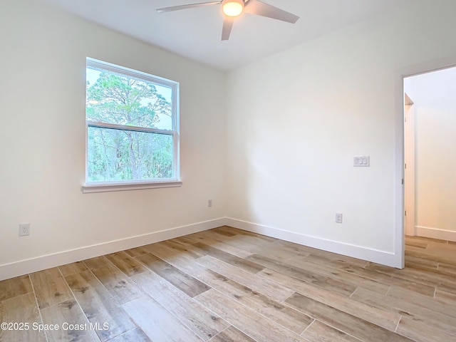 empty room with ceiling fan and light wood-type flooring