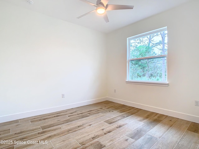 empty room with ceiling fan and light hardwood / wood-style floors