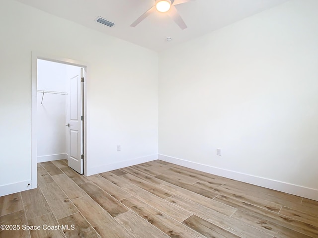 spare room with light hardwood / wood-style floors and ceiling fan