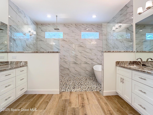 bathroom featuring vanity and shower with separate bathtub