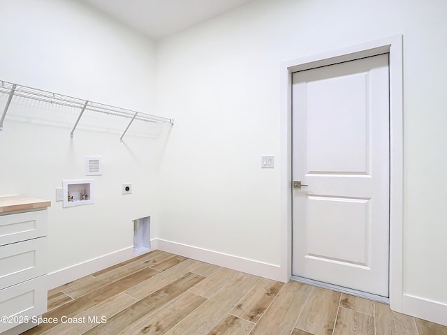 laundry area with light wood-type flooring, hookup for a washing machine, and hookup for an electric dryer