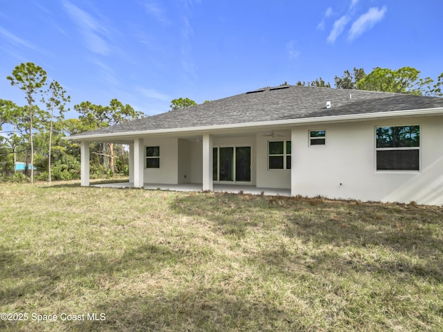 rear view of property featuring a yard and a patio