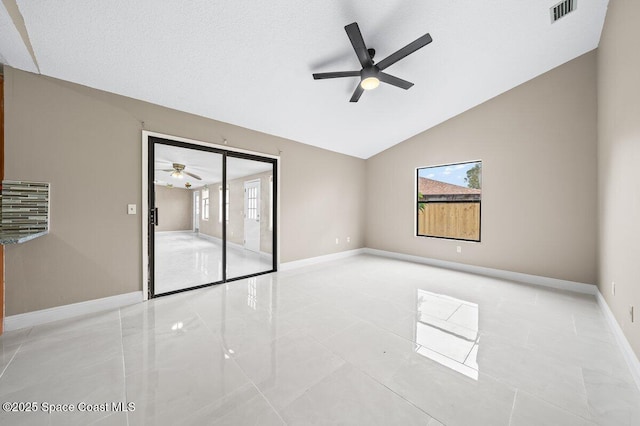 unfurnished room with ceiling fan, vaulted ceiling, and a healthy amount of sunlight