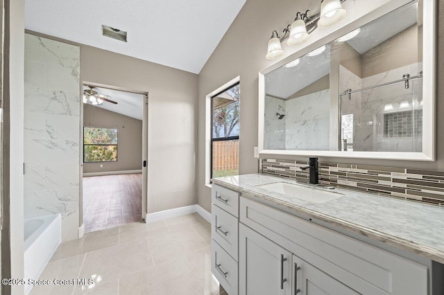 bathroom with vaulted ceiling, tile patterned flooring, tasteful backsplash, ceiling fan, and vanity