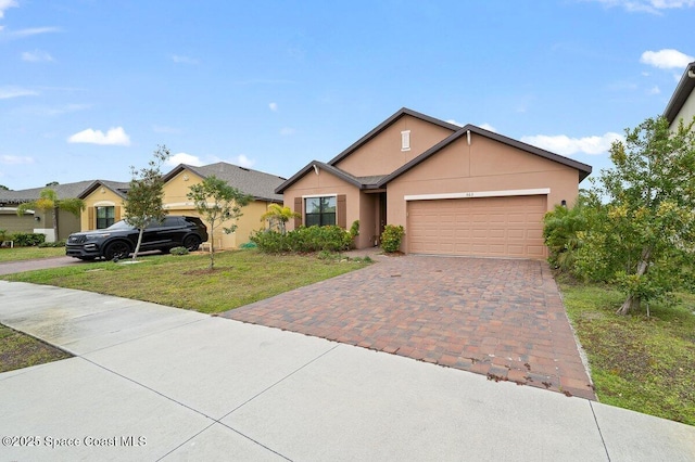 ranch-style home featuring a front yard and a garage