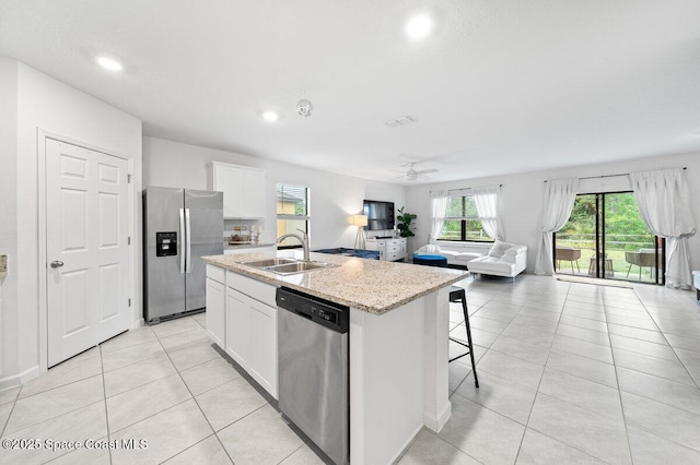 kitchen with sink, white cabinets, ceiling fan, a kitchen island with sink, and appliances with stainless steel finishes