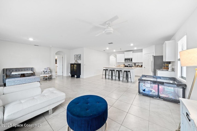 living room with ceiling fan and light tile patterned floors