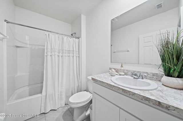 full bathroom featuring vanity, tile patterned flooring, toilet, and shower / bath combo with shower curtain