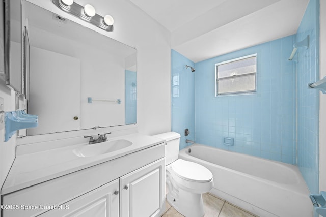 full bathroom featuring tile patterned floors, tiled shower / bath combo, toilet, and vanity