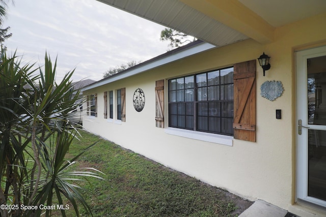 view of property exterior with a yard