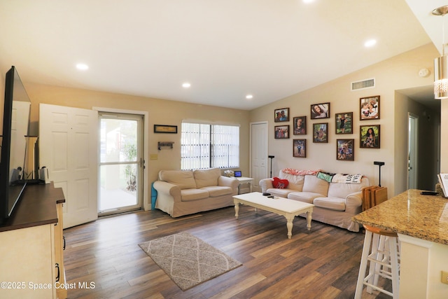 living room featuring vaulted ceiling and dark wood-type flooring