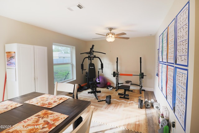 workout area featuring ceiling fan and hardwood / wood-style flooring