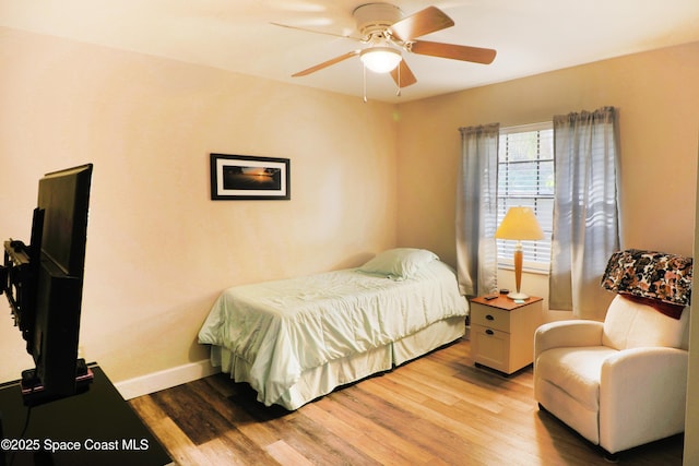 bedroom with ceiling fan and light wood-type flooring