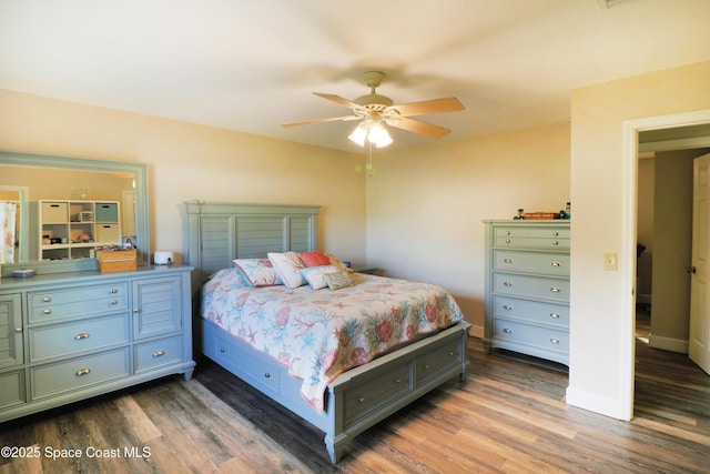 bedroom featuring ceiling fan and dark wood-type flooring