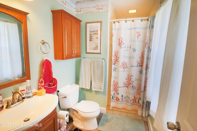 bathroom with toilet, vanity, and a shower with curtain