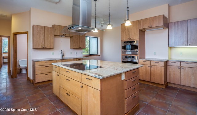 kitchen featuring island exhaust hood, black electric stovetop, light stone counters, stainless steel double oven, and decorative light fixtures