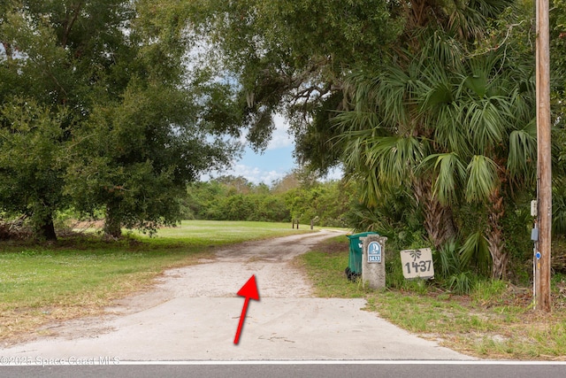 view of home's community with a yard