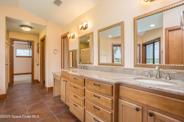 bathroom with ceiling fan, vanity, a healthy amount of sunlight, and vaulted ceiling