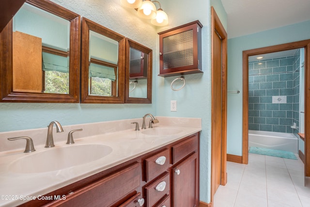 bathroom featuring vanity, tile patterned flooring, and tiled shower / bath