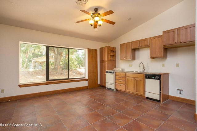 kitchen with sink, lofted ceiling, white appliances, dark tile patterned flooring, and ceiling fan