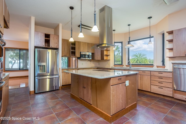 kitchen with decorative light fixtures, island exhaust hood, light stone countertops, a kitchen island, and appliances with stainless steel finishes