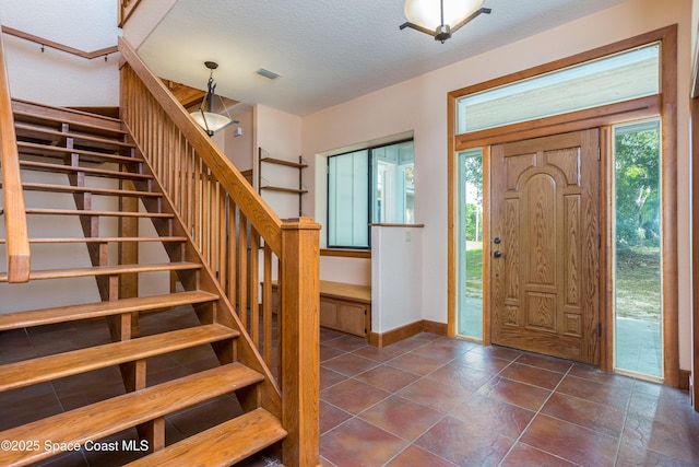 entryway featuring a textured ceiling