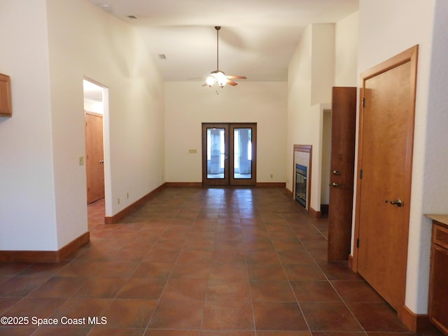 tiled entryway featuring high vaulted ceiling, french doors, and ceiling fan