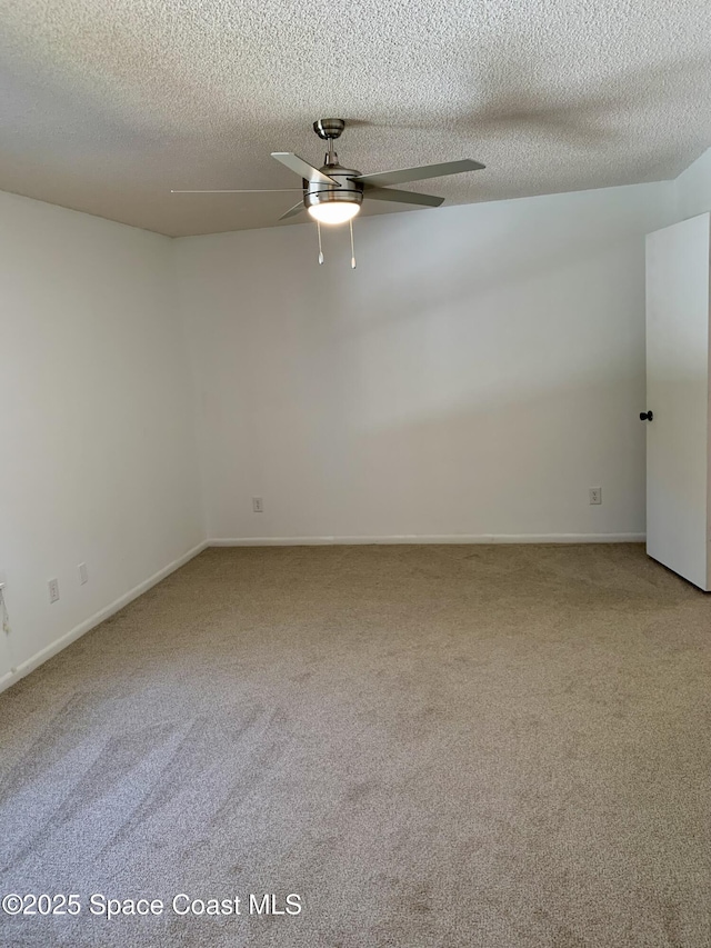 empty room with a textured ceiling, carpet floors, and ceiling fan