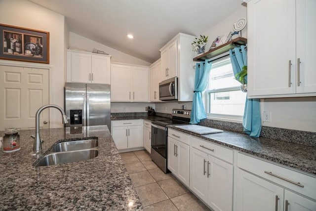 kitchen with white cabinetry, sink, lofted ceiling, and appliances with stainless steel finishes