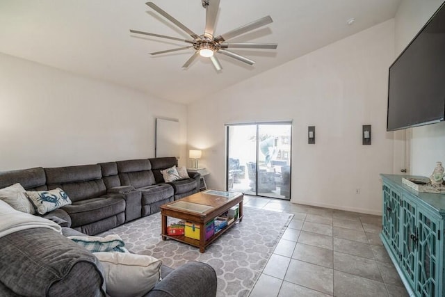 tiled living room with ceiling fan and high vaulted ceiling