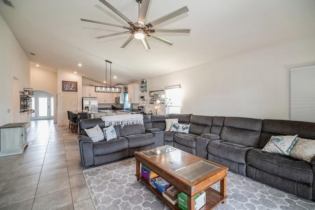 living room featuring tile patterned floors, ceiling fan, and lofted ceiling