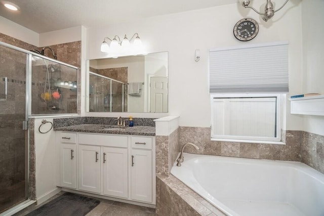 bathroom featuring vanity and shower with separate bathtub