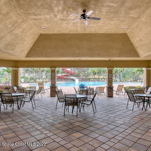 view of patio featuring ceiling fan and a community pool