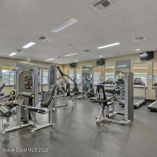 workout area with plenty of natural light and a textured ceiling