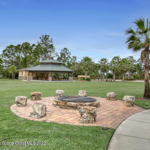 view of yard featuring a fire pit, a gazebo, and a patio