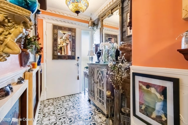 hall with light tile patterned floors and crown molding