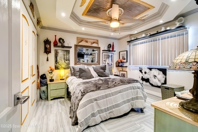 bedroom featuring ceiling fan, crown molding, and a tray ceiling