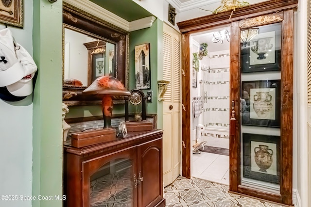 doorway featuring light tile patterned flooring and crown molding