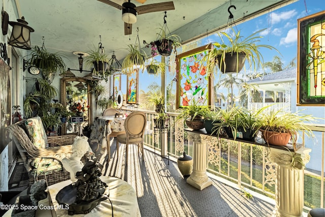 sunroom / solarium featuring ceiling fan and a wealth of natural light