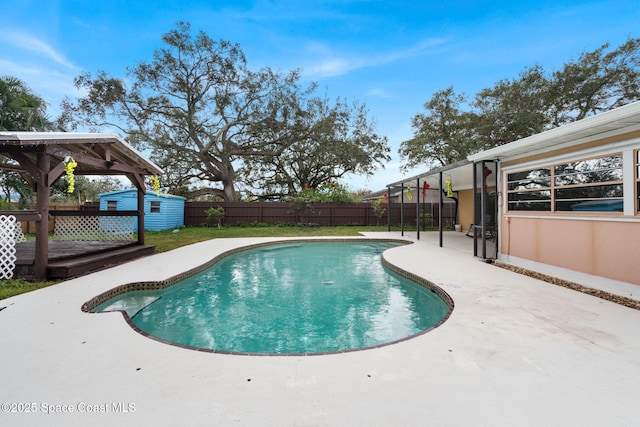 view of pool featuring a deck, a lawn, and a patio