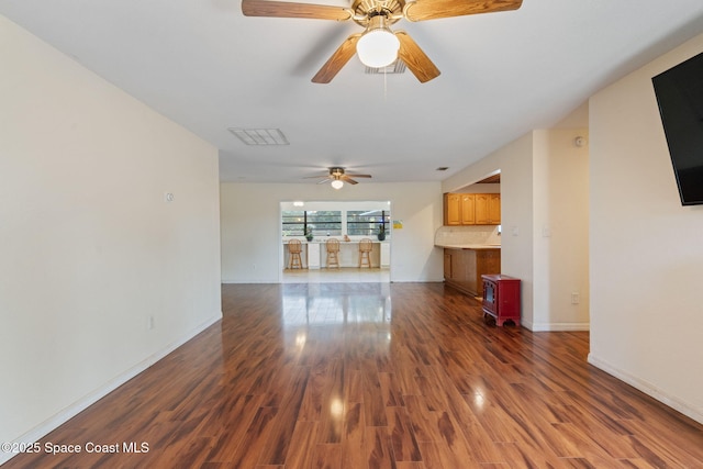 unfurnished living room with dark wood-type flooring and ceiling fan