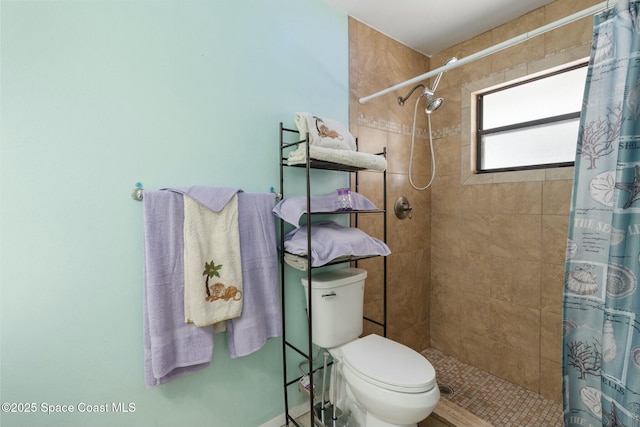 bathroom with toilet and a shower with curtain