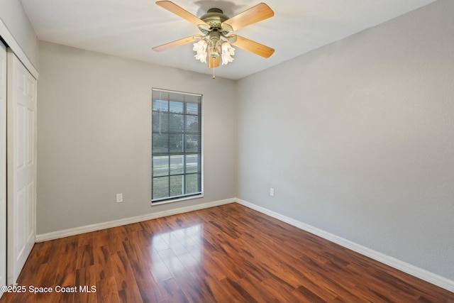 unfurnished bedroom with ceiling fan, dark hardwood / wood-style flooring, and a closet