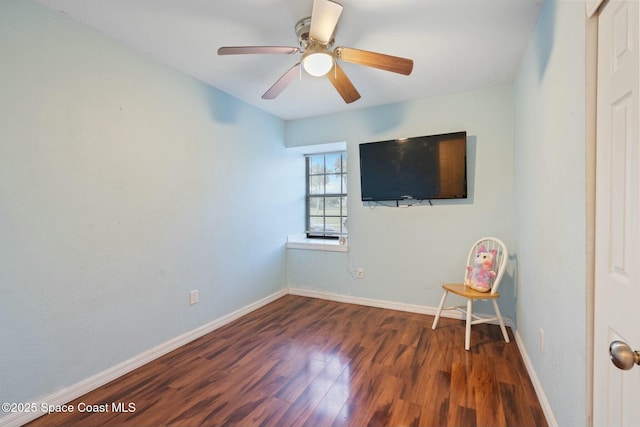 unfurnished room with ceiling fan and dark hardwood / wood-style flooring