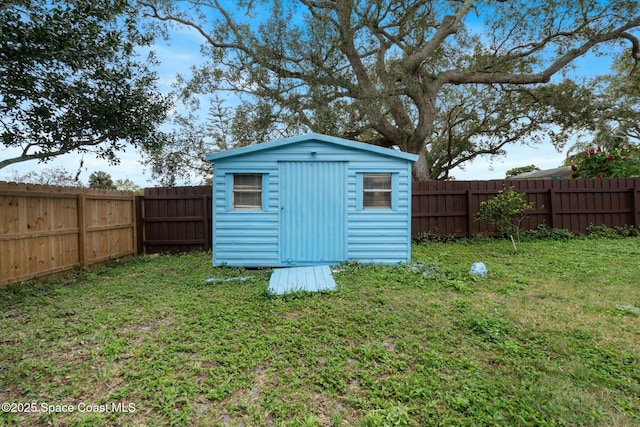 view of outdoor structure featuring a lawn