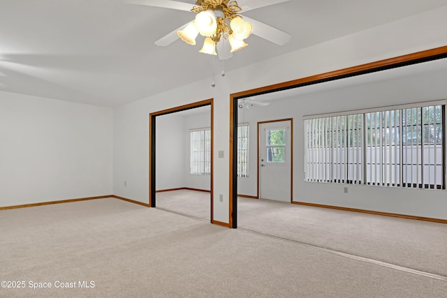 spare room featuring ceiling fan and light carpet